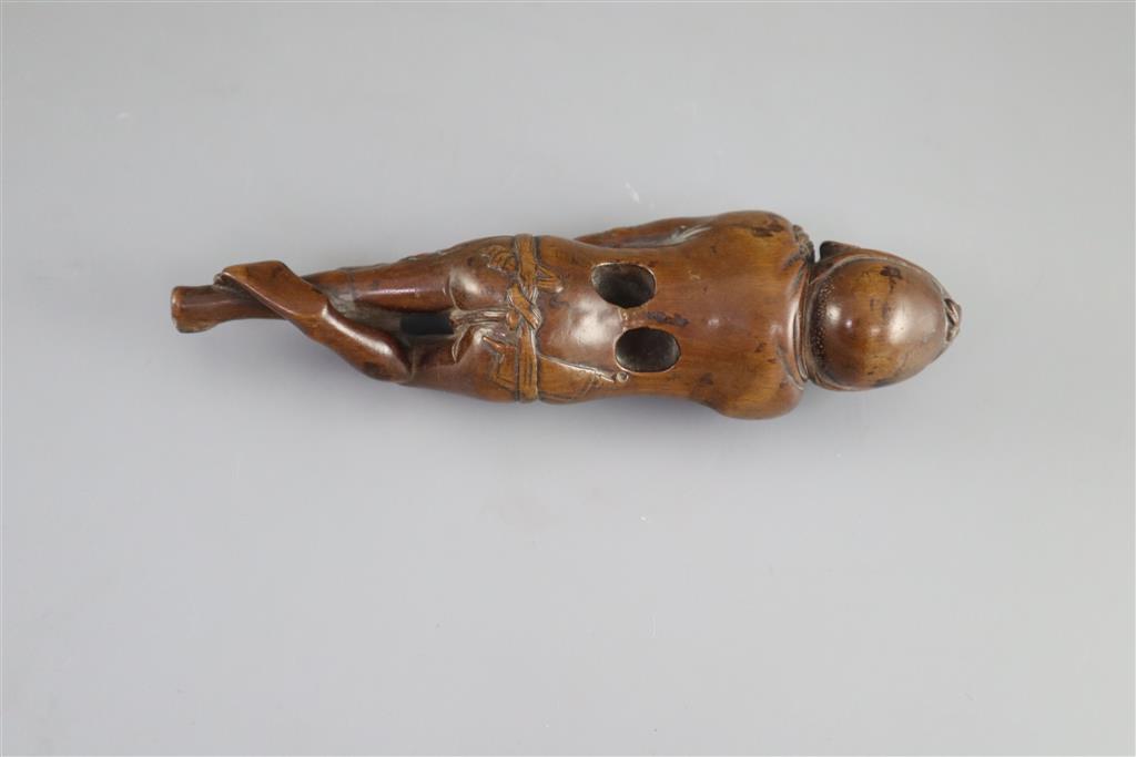 A Japanese cherrywood okimono netsuke of a farmer, early 19th century, 15cm long